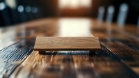 Minimalist wooden block on textured dark wood surface with dramatic lighting and shallow depth of field creating artistic composition for interior design.