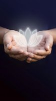 Hands of mature adult male holding glowing lotus flower symbol against dark background, representing spirituality, wellness, meditation, healing, and mindfulness practices.