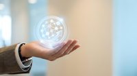 Businessman hand holding glowing digital globe with network connections in modern office environment for technology and global business concepts.