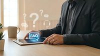 Professional businessman using laptop with FAQ digital interface and question marks floating above, representing customer support and help desk services.