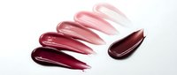 Glossy lip gloss swatches in pink and burgundy shades on white background. Cosmetic product samples for beauty and makeup applications.