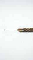 Professional precision screwdriver with textured brass handle and flathead tip isolated on white background for repair and maintenance work.