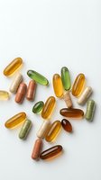 Colorful vitamin and supplement capsules scattered on white background for health and wellness concepts.