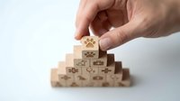 Hand placing wooden cube with paw print on pyramid of pet care blocks representing veterinary services and animal health concepts.