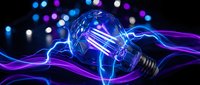 Glowing light bulb with electric energy waves and colorful bokeh lights on dark background for innovation and creativity concepts in business presentations.