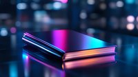 Closed book with metallic reflective cover illuminated by vibrant neon pink and blue lights against dark background with bokeh effect creates futuristic atmosphere.