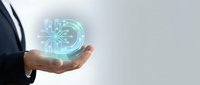 Businessman hand holding glowing digital circuit board hologram representing artificial intelligence and future technology innovation in corporate environment.