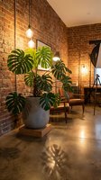 Modern industrial loft interior with exposed brick walls, monstera plant in concrete pot, pendant lighting and warm ambient atmosphere for home decor.