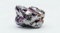 Iridescent bismuth crystal specimen with rainbow metallic surface displaying purple, blue and silver hues on white background for mineral collection.