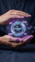 Male hands holding glowing neon improvement cycle diagram with plan, do, check, act phases for business process management and quality control concepts.