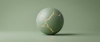 Cracked sphere with gold kintsugi repair lines on matte green surface, symbolizing resilience and healing in modern design projects.