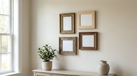 Four rustic wooden frames arranged on a beige wall above a console table with a green plant and ceramic vase, cozy interior mockup.
