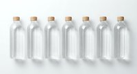 Seven clear glass bottles with cork stoppers arranged in row on white background isolated for packaging design and product mockups.