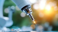 Professional microscope objective lens with precision optics capturing scientific research in modern laboratory setting with warm lighting effects.