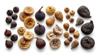 Dried figs and walnuts arranged on white background, showcasing natural organic ingredients for cooking, baking, nutrition and healthy food design projects.