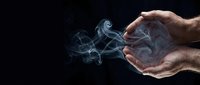 Cupped hands gently holding ethereal white smoke against dark background, symbolizing protection, care, and spiritual energy in mystical atmosphere.