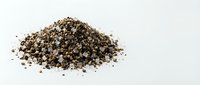 Pile of freshly ground black pepper spice isolated on white background for culinary cooking and seasoning applications.