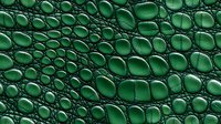 Emerald green crocodile skin texture with detailed scales and natural leather pattern showing intricate reptilian surface structure in macro photography.