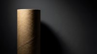 Brown cardboard tube casting dramatic shadow on dark textured surface. Minimalist industrial composition with warm lighting and geometric forms.