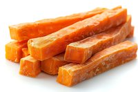 Fresh orange cheddar cheese cut into long sticks isolated on white background, dairy snack food photography for commercial and advertising use.