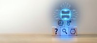 Glowing AI processor chip hologram above wooden blocks with technology icons, representing artificial intelligence and digital innovation concept.