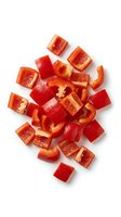 Freshly chopped red bell pepper pieces isolated on white background, vibrant diced vegetable for healthy cooking and recipe design use.