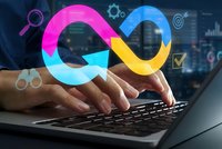 Businessman typing on laptop with colorful infinity symbol representing endless possibilities and continuous workflow in modern office.