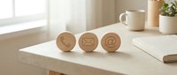 Wooden contact icons with envelope and at symbol on desk, representing email communication and digital messaging channels for business correspondence.