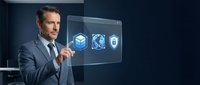Professional businessman in suit interacting with futuristic holographic interface displaying technology icons in modern office environment.