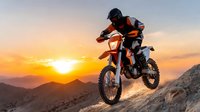 Motocross rider jumping dirt bike at sunset over mountain landscape with dramatic orange sky and rocky terrain for extreme sports adventure.