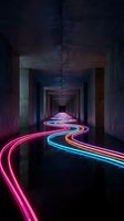 Neon light trails flowing through dark concrete tunnel corridor creating vibrant pink blue orange streaks in urban underground passage architecture.