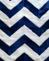 Navy blue and white chevron pattern on soft furry textile creates modern geometric design. Seamless repeat for fabric, wallpaper and home decor projects.