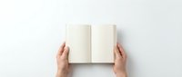 Hands holding open blank notebook with empty white pages on clean white background, top view perspective for mockup and design projects.