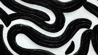 Abstract black wavy brush strokes on white textured background creating dynamic pattern for modern graphic design projects.