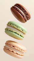 Three colorful French macarons floating on beige background - chocolate, pistachio and strawberry flavored sandwich cookies for bakery menu design.