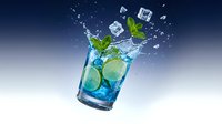 Blue cocktail with lime slices and mint leaves splashing with ice cubes against gradient background for beverage advertising and summer drink promotions.