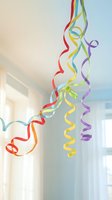 Colorful party streamers hanging in bright room creating festive celebration atmosphere for birthday events and holiday decorations.