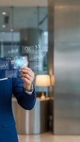 Businessman in blue suit interacting with holographic digital interface displaying analytics, charts, and growth metrics in modern office environment for business technology concepts.