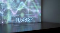 Digital holographic display showing time 10:48:32 with futuristic interface elements and colorful light projections in modern tech environment.