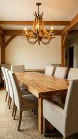 Rustic dining room with antler chandelier, wooden table and upholstered chairs in modern farmhouse interior design for home decor inspiration.
