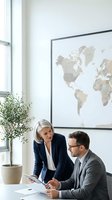 Professional business colleagues discussing strategy in modern office with world map for corporate planning and global expansion meetings.