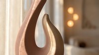 Modern abstract wooden sculpture with curved organic form on windowsill in bright contemporary interior with warm lighting for home decor and design.