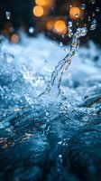 Dynamic water splash with floating droplets captured in macro against blurred orange bokeh lights, creating mesmerizing patterns in blue tones. Perfect for freshness concepts.