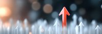 Red arrow rising among white arrows against blurred bokeh background, symbolizing leadership, growth and standing out from competition in business concept.