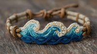 Handcrafted wave pattern bracelet with blue ombre thread design on natural hemp cord, perfect for beach-themed accessories.