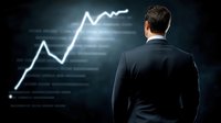 Asian businessman in dark suit looking at glowing financial chart showing upward trend against black background. Market analysis and growth concept.