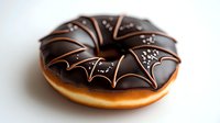 Chocolate glazed donut decorated with bat wing pattern and silver sprinkles on white background, Halloween themed dessert for seasonal menu and party treats.