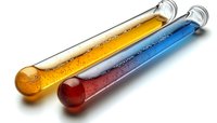 Glass test tubes with colorful chemical liquids showing bubbles and reactions against white background, scientific laboratory research concept.