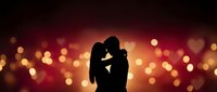 Romantic couple silhouette embracing against warm bokeh lights background for Valentine's Day, wedding, anniversary and love celebration designs.