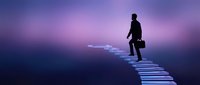 Silhouetted male professional in business suit walking across illuminated bridge toward glowing light, representing career advancement, success, and future opportunities for corporate and motivational content.